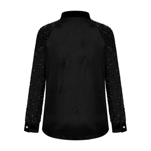 Back view of a black velvet shirt with sparkling sequined long sleeves and high texture
