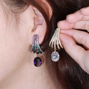 Elegant long drop earrings with brass inlays and colorful cubic zirconia on ear