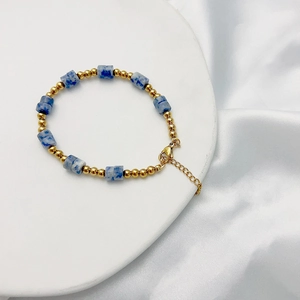 Detailed view of bohemian bracelet featuring marble beads and gold lobster clasp