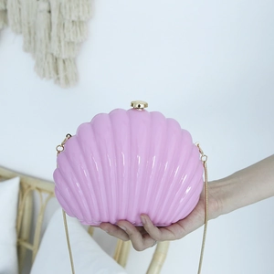 Pink shell-shaped acrylic evening clutch bag with gold chain strap for women