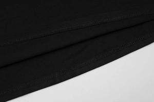 Detailed close-up of double-stitched hem and premium black knit fabric texture