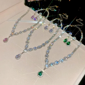 Detailed view of teardrop zircon jewelry sets in pink, white, and emerald green colors
