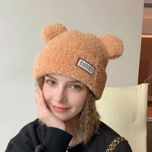 Cute brown plush knitted winter hat with bear ears and thick thermal lining for women