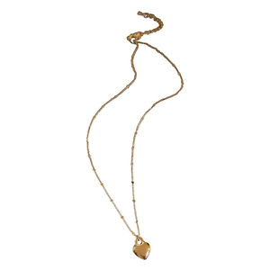 Minimalist golden heart pendant necklace with adjustable chain on white background