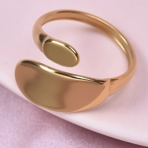 Close-up of polished golden stainless steel ring with minimalist curved line design