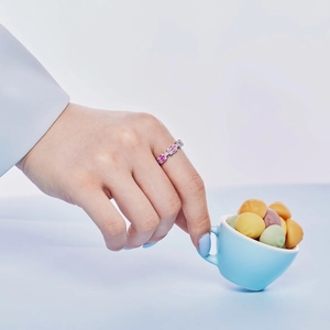Detail of S925 sterling silver ring with colorful square-cut zircons on female hand