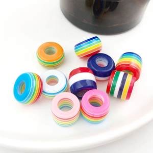 Close-up of rainbow striped 8x14mm resin barrel beads with large holes for DIY jewelry