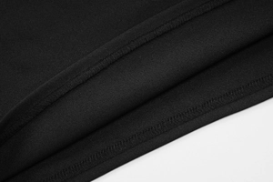 Macro shot of woven fabric texture and double-needle stitching on black tube top hem