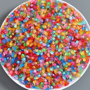Macro shot of colorful luminous resin mini turtles in a white bowl for DIY creative crafts