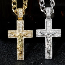 Detailed close-up of gold and silver hip-hop Jesus cross pendants with iced out crystals