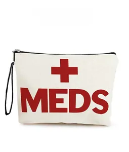 Detail of white canvas medical pouch with red MEDS print and black zipper closure