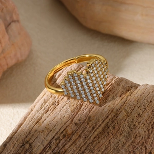 Detailed view of an open golden heart ring featuring sparkling white zircon inlay