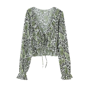 Detail of paisley print long sleeve blouse with tie-front and ruffled elastic cuffs