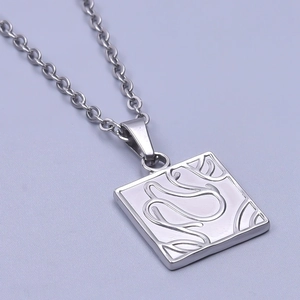 Macro shot of silver square pendant with abstract curved texture and metallic chain
