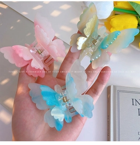 Detail of colorful gradient butterfly hair clips with elegant 3D acetate design