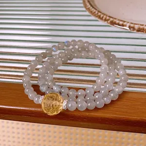 Multi-layer moonstone beaded bracelet featuring a yellow rose charm in retro style