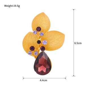 Vintage gold leaf brooch with purple rhinestones and dark red crystal teardrop pendant