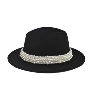 Detalle del sombrero fedora de fieltro negro con elegante adorno de banda de perlas blancas