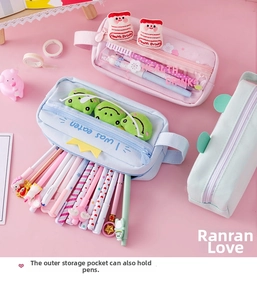 Detail of large canvas pencil case with clear PVC pockets and cute plush charms