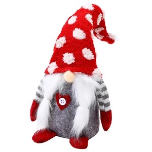 Nordic Christmas gnome plush with red heart and knit hat on white background