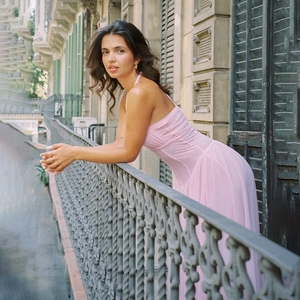 Detail of elegant pink halter neck dress featuring pleated texture and flattering cinched waist