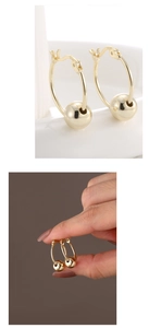Detailed macro view of S925 sterling silver gold earrings with sliding beads