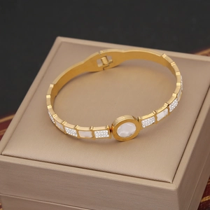 Detail of gold-plated bangle with mother of pearl inlays and micro-pave zircons