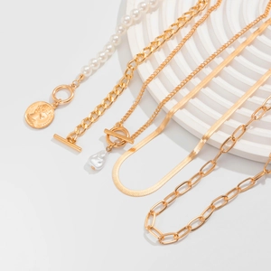 Set of five gold necklaces featuring baroque pearls snake chain and coin pendants on base