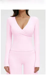 Detail of V-neck long sleeve yoga top with cross-front pleats in Cherry Blossom Pink