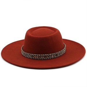 Detail of rust red wool flat top hat featuring a bohemian triple braided hatband design