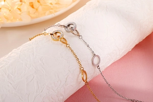 Detail of interlocking circles on gold and silver bracelets with micro-pave crystals