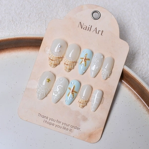 Detailed 3D shell texture and starfish design on handmade ocean themed press-on nails