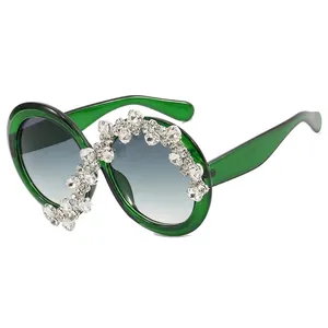 Oversized green translucent sunglasses for women with asymmetric crystal embellishments