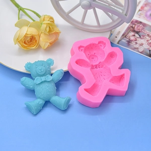 Pink bear silicone mold with textured fur and finished resin craft on a blue background