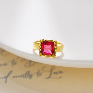 Detailed macro view of vintage gold ring featuring a square pink zircon with rope border