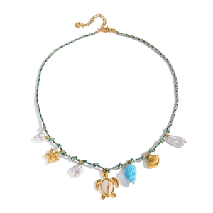 Detailed view of bohemian woven cord necklace with gold sea turtle and starfish charms