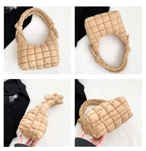 Detail view of khaki quilted puffer bag with padded squares and decorative knotted handle