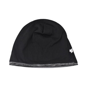 Detailed close-up of a soft black and heather grey knitted beanie with a care label
