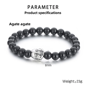 Detail of 8mm black agate beads and vintage silver skull charm on men's stretch bracelet