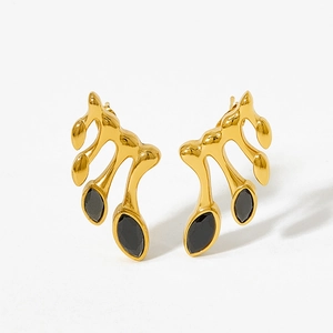 Detail of vintage geometric earrings with gold finish and black marquise zircon stones