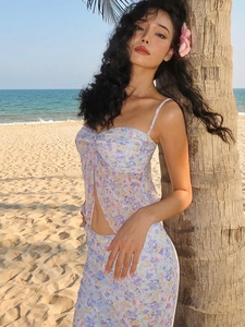 Floral two-piece mesh set with crop camisole and midi skirt against beach background