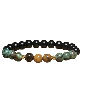 Detail of beaded bracelet with natural stone and gold stainless steel ring cross element