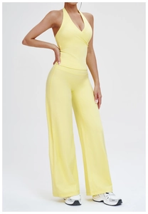 Detail of yellow halter neck yoga top and high waist wide leg sports trousers set