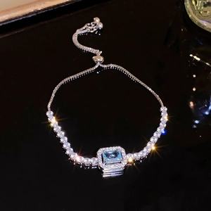 Elegant starburst zircon pearl bracelet with sky blue center stone and adjustable chain