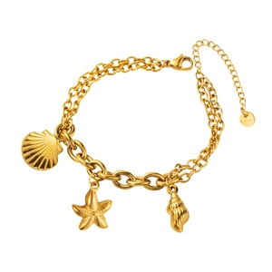 Detail of gold double-layer stainless steel bracelet featuring starfish and seashell charms
