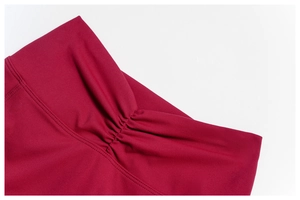 Detail view of burgundy high waist yoga shorts with scrunch butt seam and sewing
