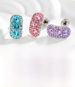 Macro detail of oval stud earrings with blue, pink, and purple micro-set zircon crystals