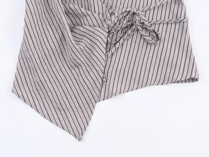Detail of irregular hem shirt with maroon stripes and side bow tie decoration