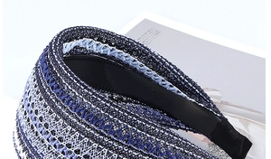 Detailed view of wide woven headband with blue mesh texture and non-slip inner teeth