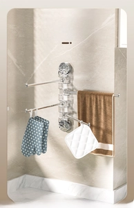 Detail of a rotating suction cup towel rack with 4 bars for bathroom corner storage
